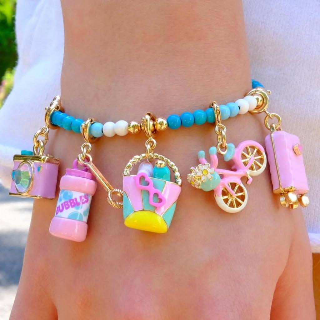 CHARM IT! Vacay All Day Charm Bracelet with Vacation themed charms on an aqau colored bracelet.