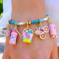 CHARM IT! Vacay All Day Charm Bracelet with Vacation themed charms on an aqau colored bracelet.